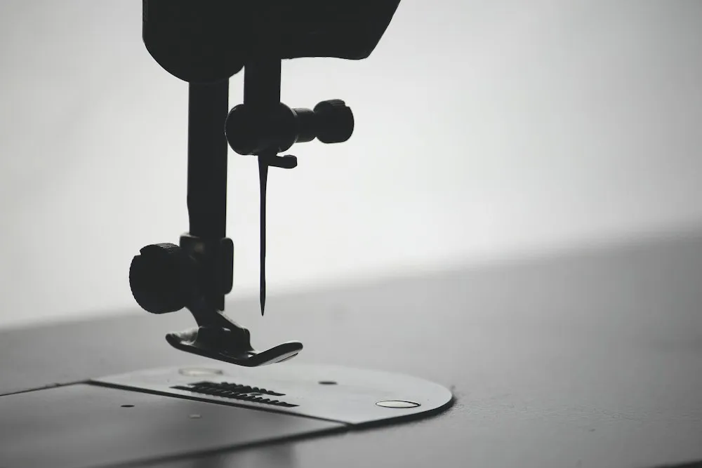 Close-up of the needle and presser foot of a sewing machine
