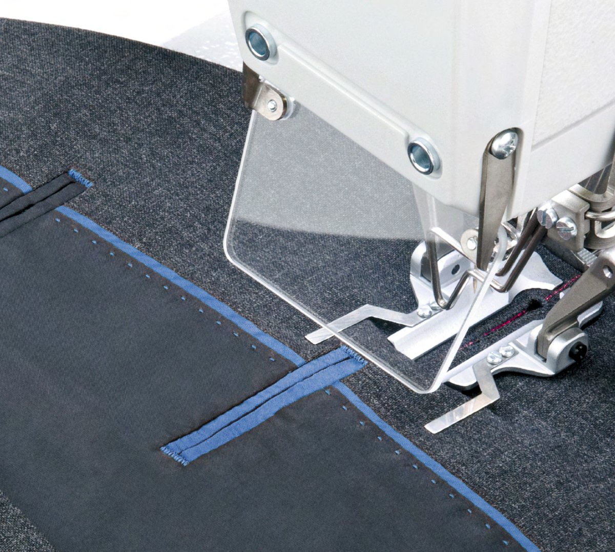 Industrial sewing machine sewing a piped pocket on a jacket
