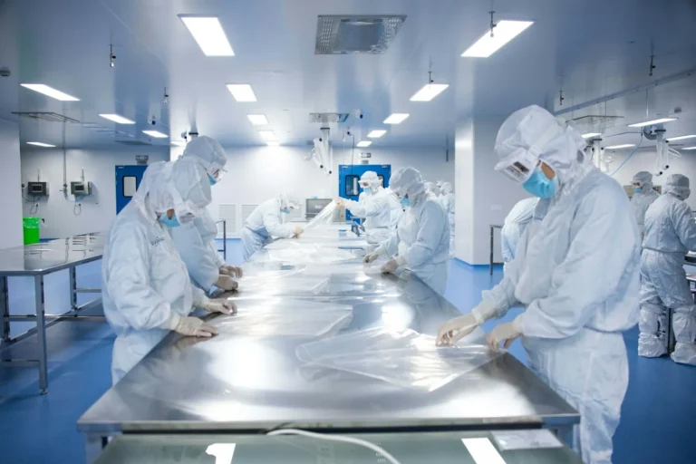 Workers in protective overalls in a cleanroom